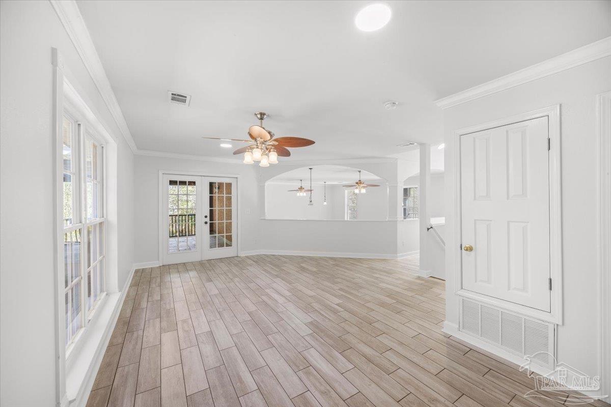 2099 Garcon Point Road Milton, FL 32583 - Photo 40 of 65 a view of an empty room with wooden floor and a window