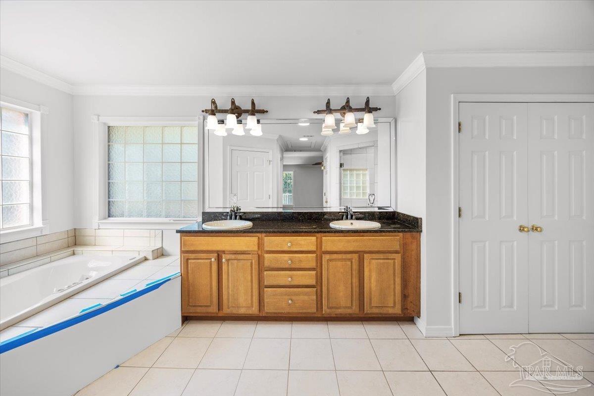 2099 Garcon Point Road Milton, FL 32583 - Photo 48 of 65 a large bathroom with a large tub sink and cabinets