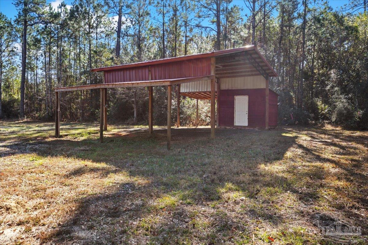 2099 Garcon Point Road Milton, FL 32583 - Photo 59 of 65 a view of a house with a yard