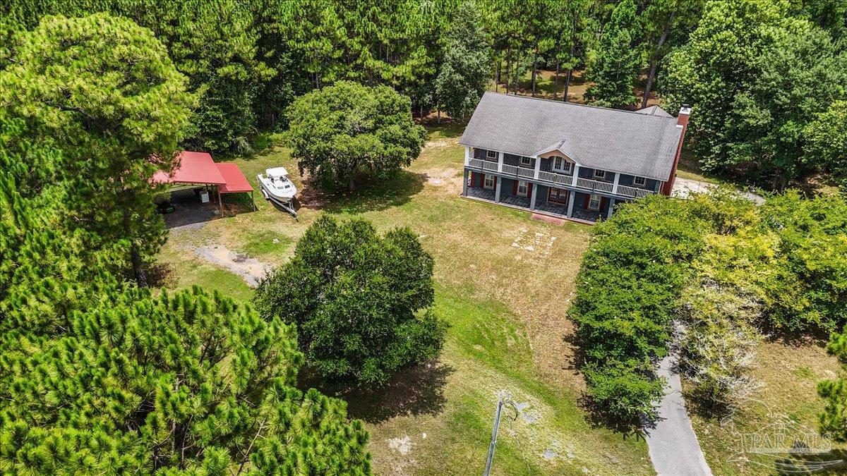 2099 Garcon Point Road Milton, FL 32583 - Photo 6 of 65 an aerial view of a house with a yard and large trees