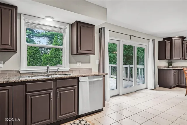 a kitchen with granite countertop a sink and a stove
