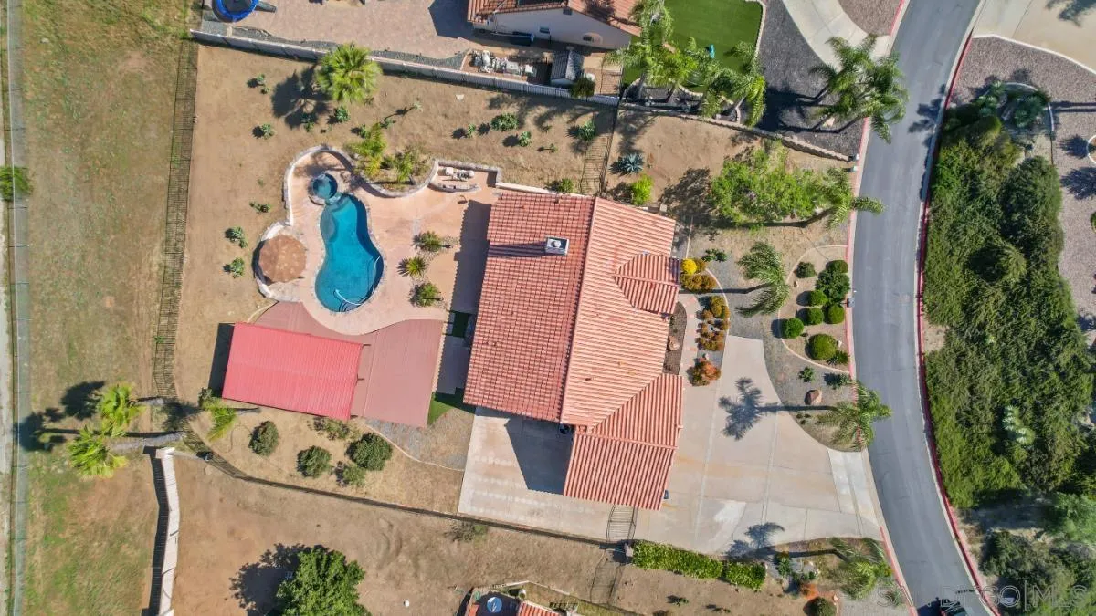 an aerial view of residential house with outdoor space and parking