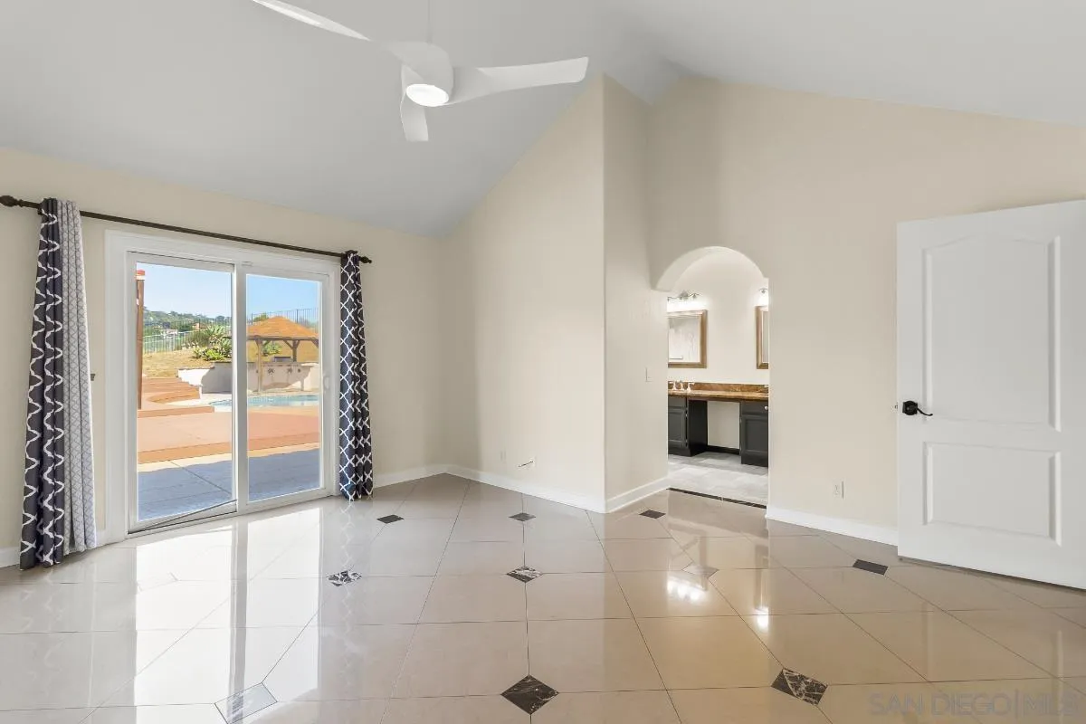 404 Summerhill Terrace Alpine, CA 91901 - Photo 18 of 40 a view of an empty room with a fireplace and a window