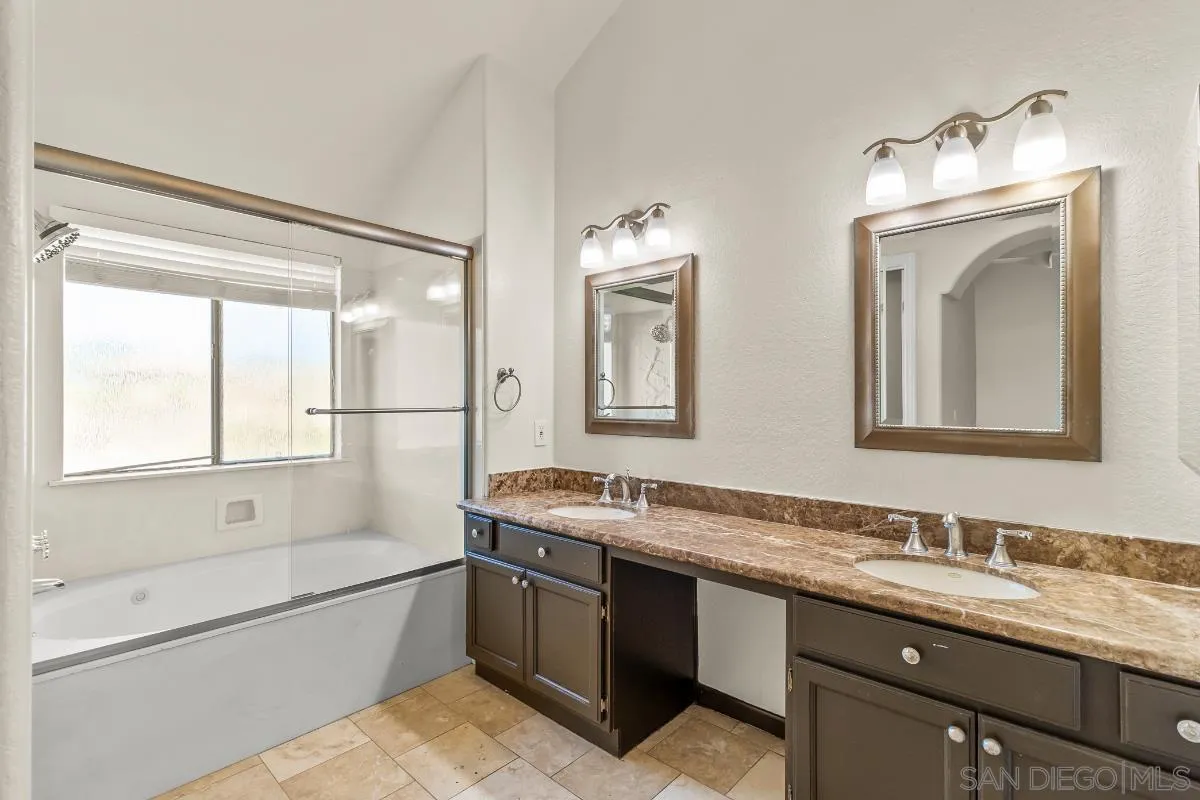 404 Summerhill Terrace Alpine, CA 91901 - Photo 20 of 40 a bathroom with a granite countertop sink mirror and a bathtub