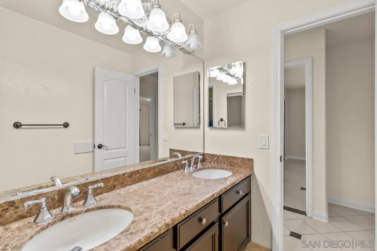 404 Summerhill Terrace Alpine, CA 91901 - Photo 21 of 40 a bathroom with a granite countertop double vanity sink and a mirror