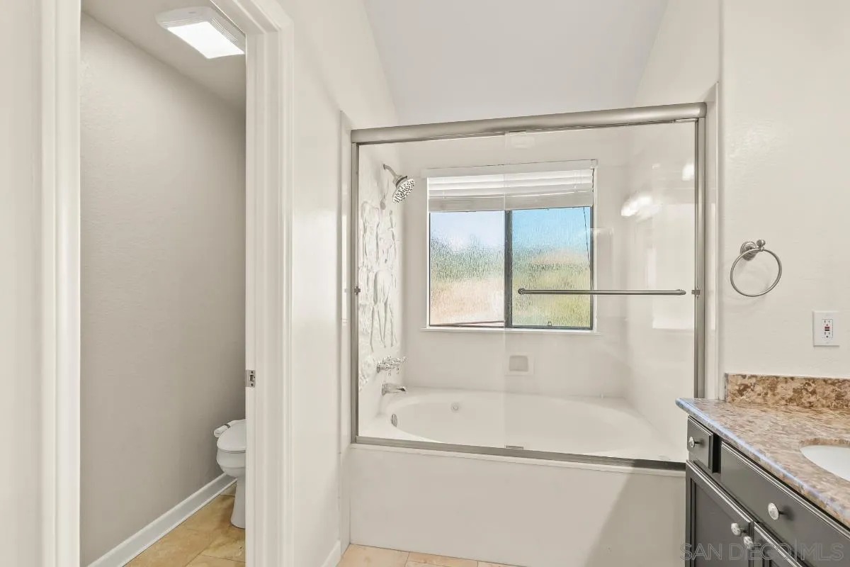 404 Summerhill Terrace Alpine, CA 91901 - Photo 22 of 40 a bathroom with a tub and a shower