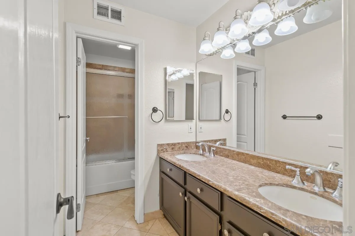 404 Summerhill Terrace Alpine, CA 91901 - Photo 23 of 40 a bathroom with a granite countertop sink a mirror and a shower