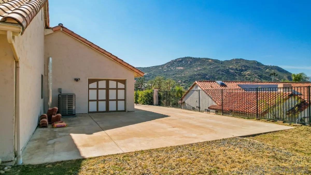 404 Summerhill Terrace Alpine, CA 91901 - Photo 35 of 40 a backyard of a house with large trees and more windows
