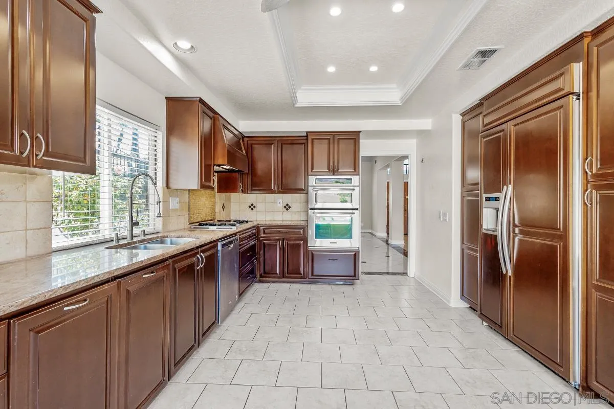 404 Summerhill Terrace Alpine, CA 91901 - Photo 8 of 40 a large kitchen with stainless steel appliances granite countertop a refrigerator and a sink