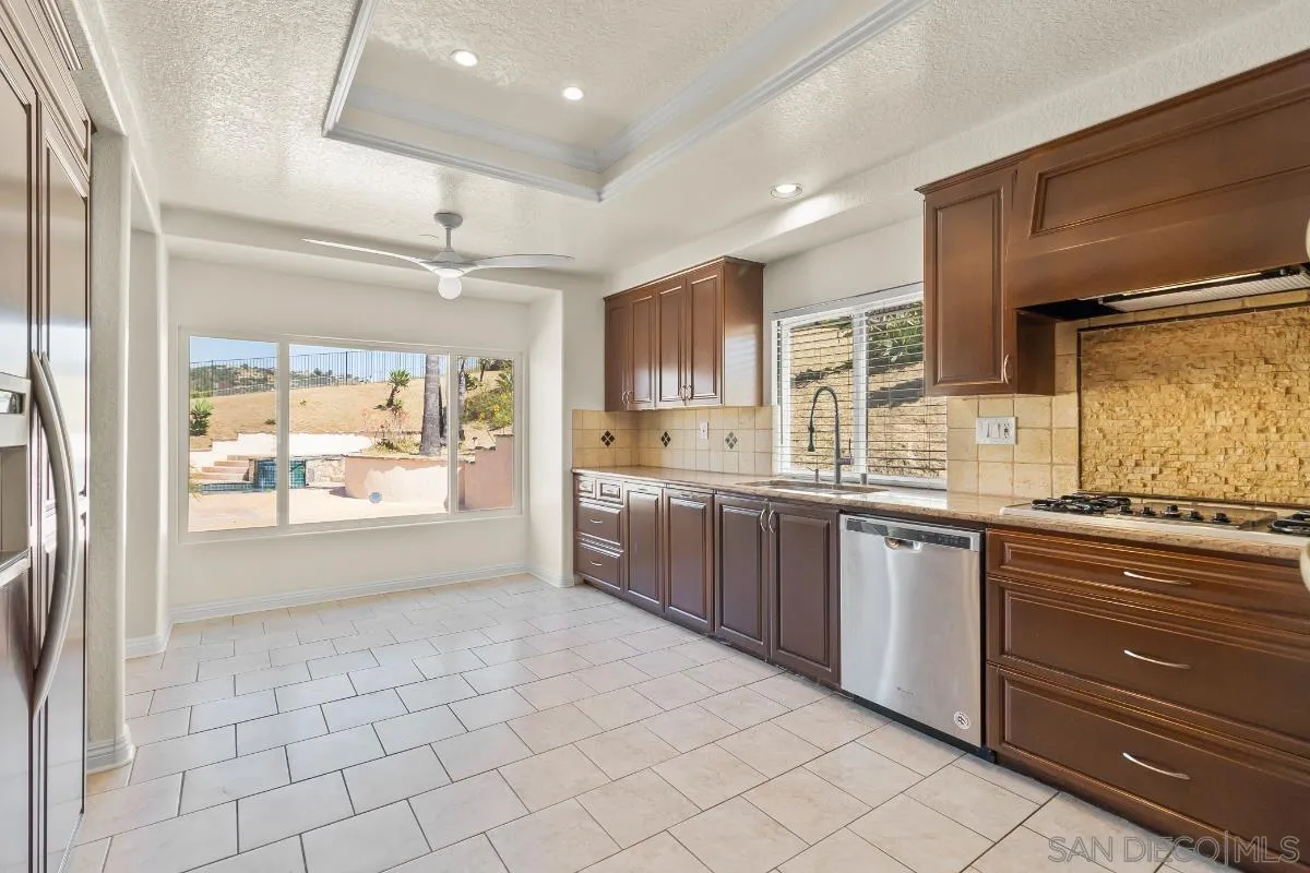 404 Summerhill Terrace Alpine, CA 91901 - Photo 9 of 40 a large kitchen with kitchen island granite countertop a large window