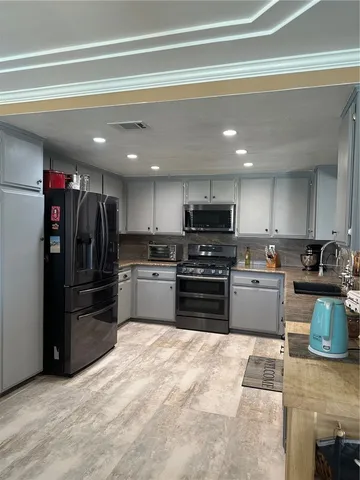 a kitchen with a refrigerator and a sink