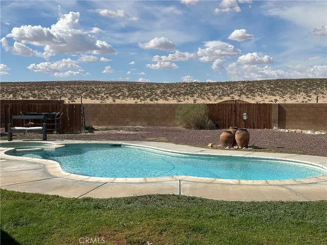 a backyard of a house with barbeque oven fire pit table and chairs