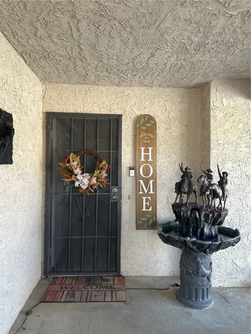 a vase of flowers sitting on a table in front of a door