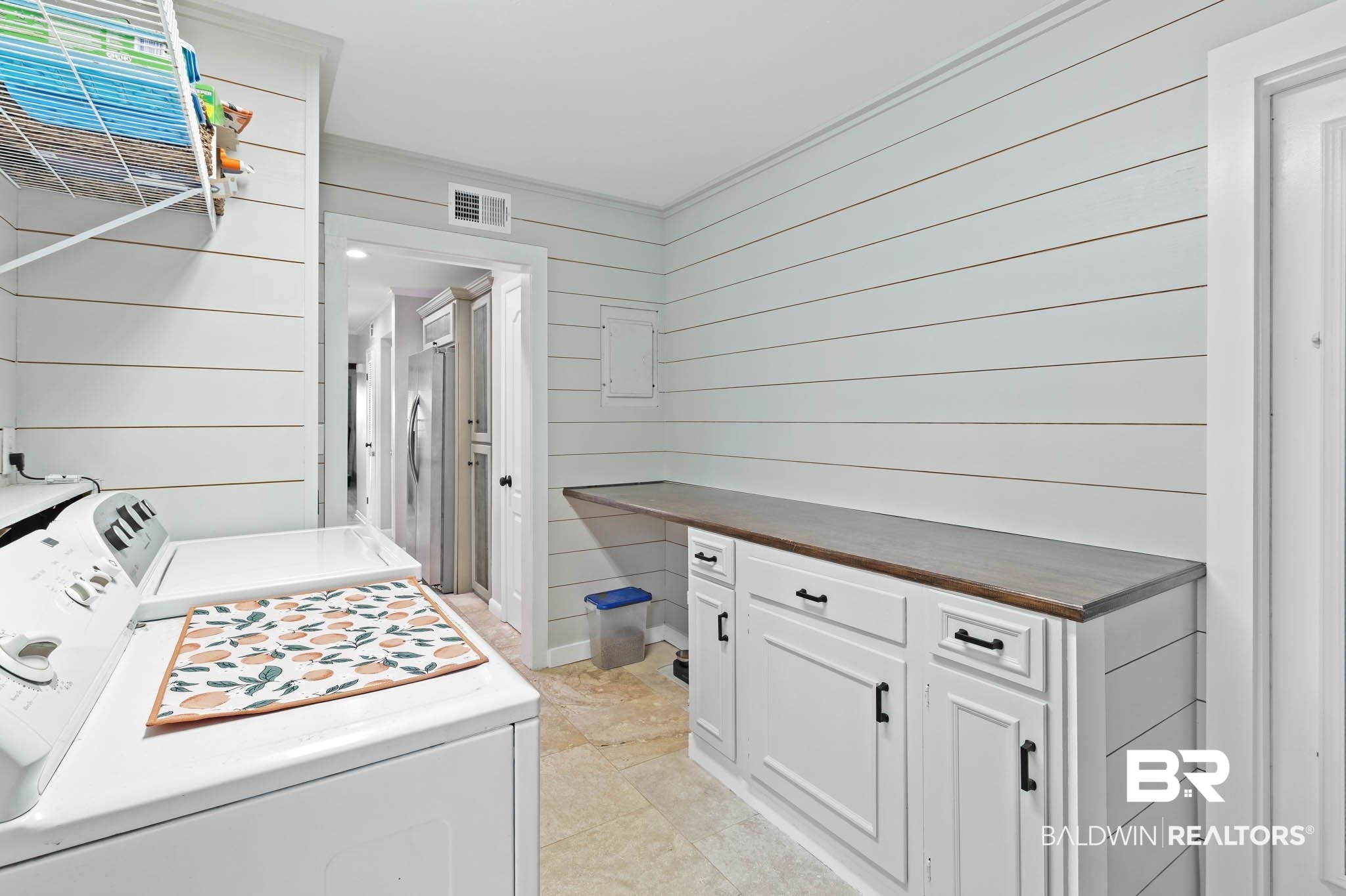 608 Southern Way Daphne, AL 36527 - Photo 31 of 35 Laundry room featuring wooden walls, separate washer and dryer, and light tile patterned floors