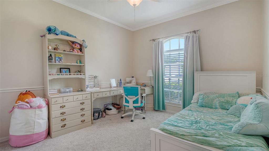 7717 US Open Loop Lakewood Ranch, FL 34202 - Photo 25 of 95 a bedroom with a bed and a window