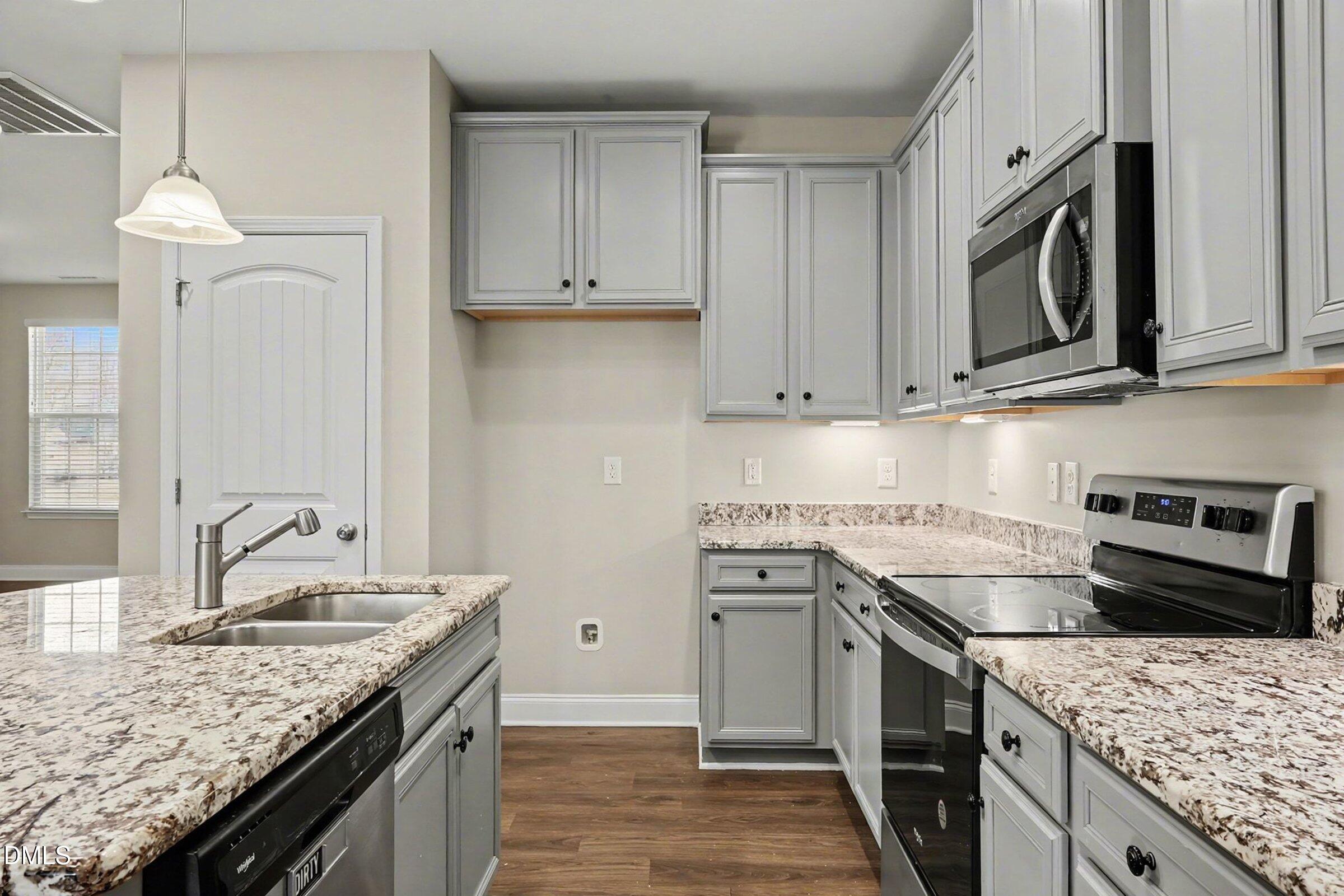 1946 Payne Road Haw River, NC 27258 - Photo 11 of 37 a kitchen with stainless steel appliances granite countertop a sink stove and refrigerator