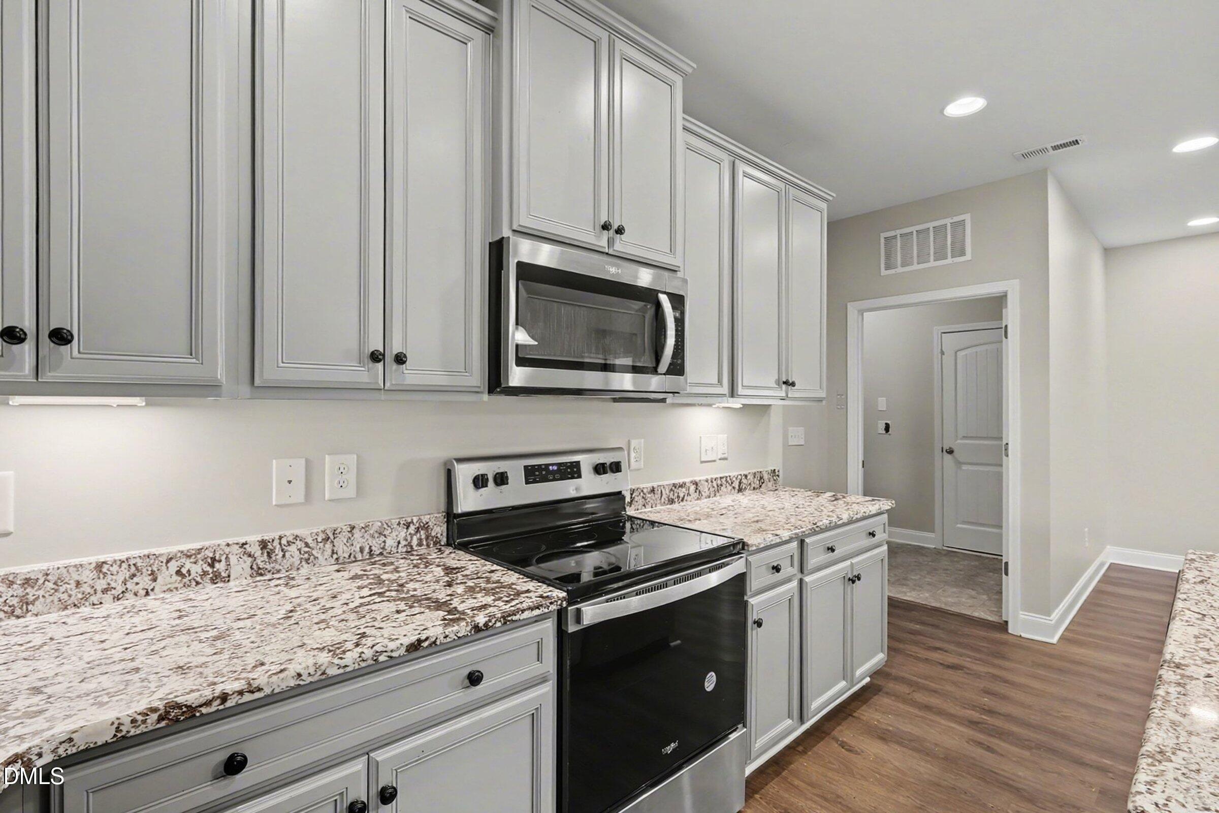 1946 Payne Road Haw River, NC 27258 - Photo 14 of 37 a kitchen with stainless steel appliances granite countertop a stove a sink and a microwave