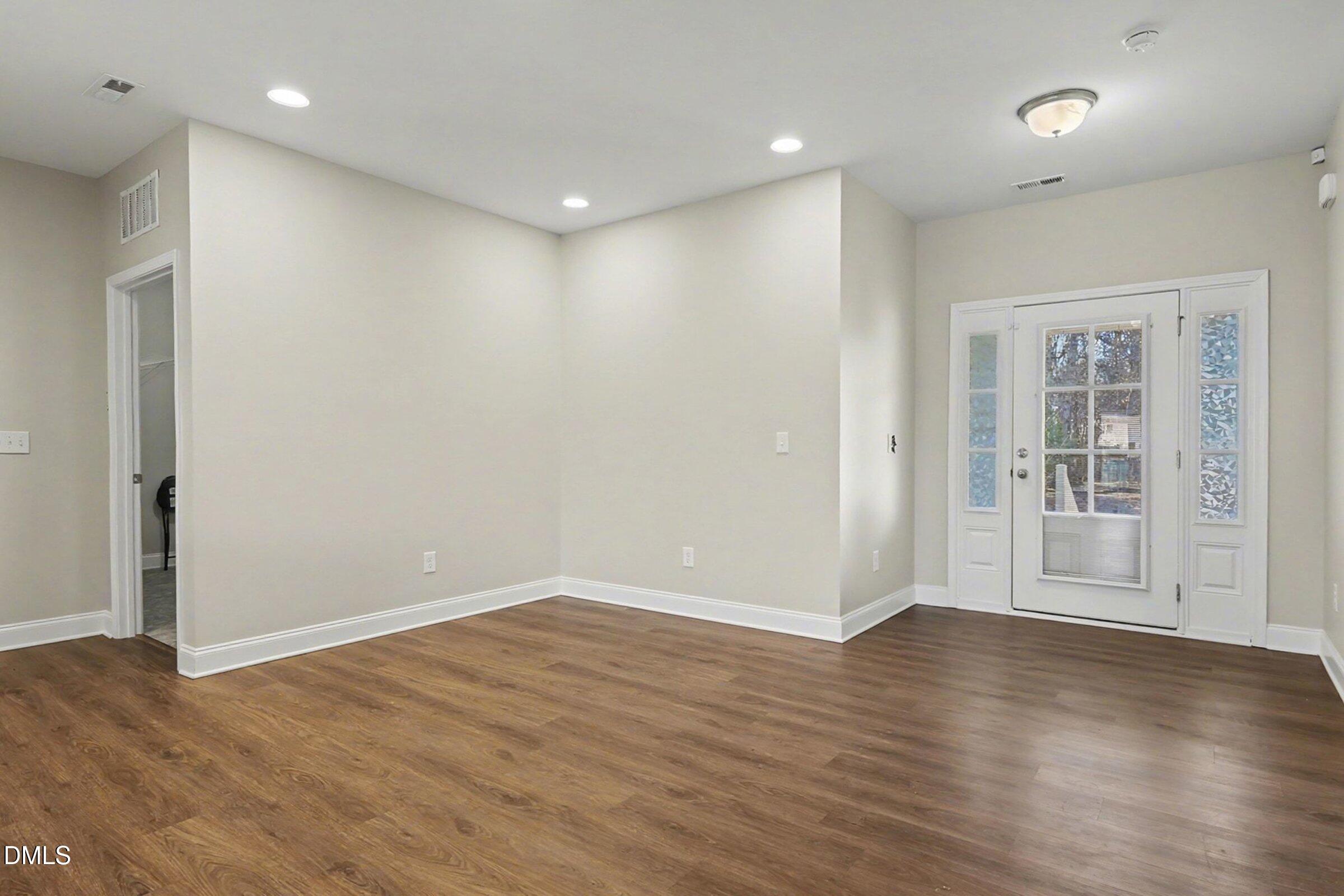 1946 Payne Road Haw River, NC 27258 - Photo 15 of 37 an empty room with wooden floor and windows