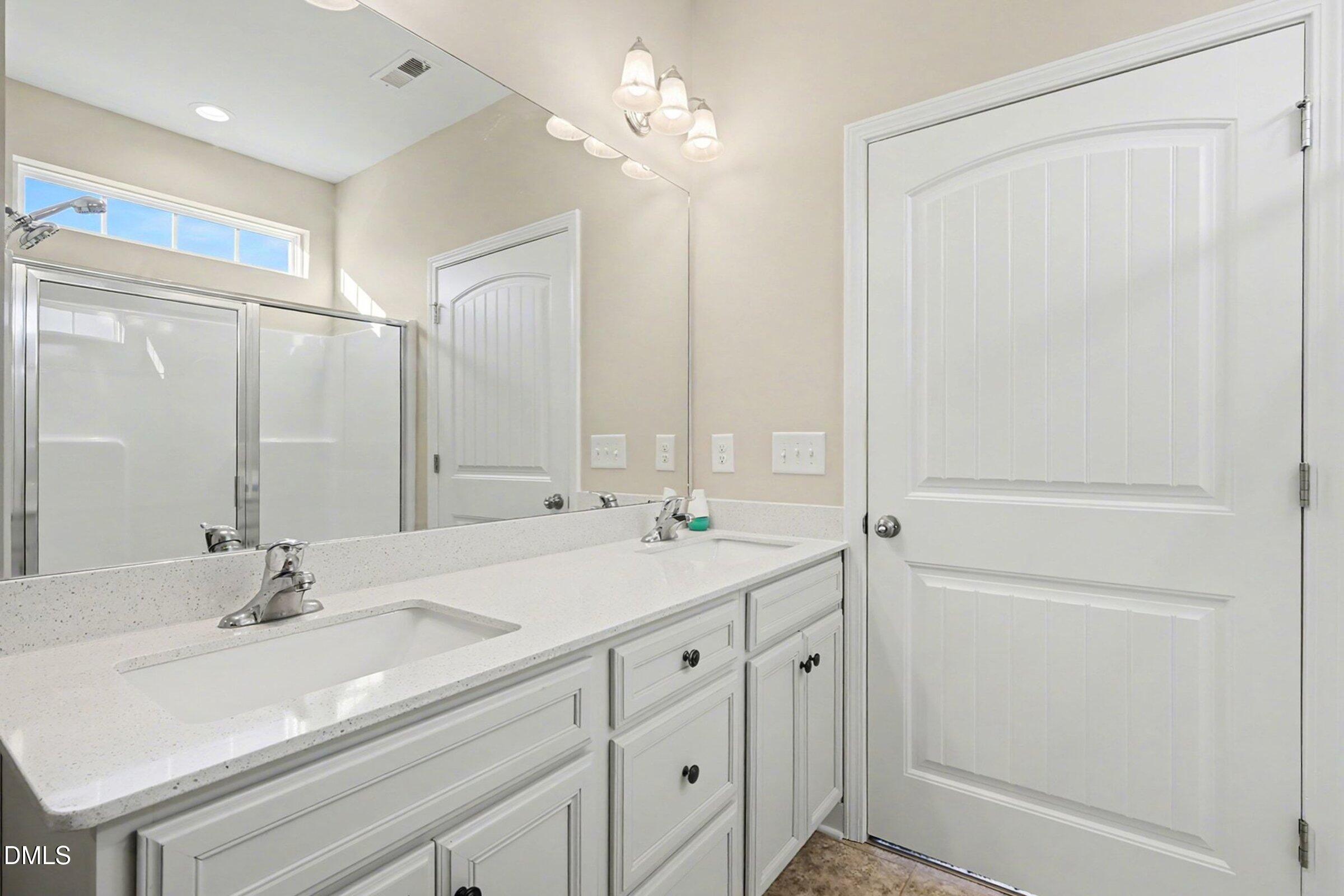 1946 Payne Road Haw River, NC 27258 - Photo 27 of 37 a bathroom with a double vanity sink mirror and