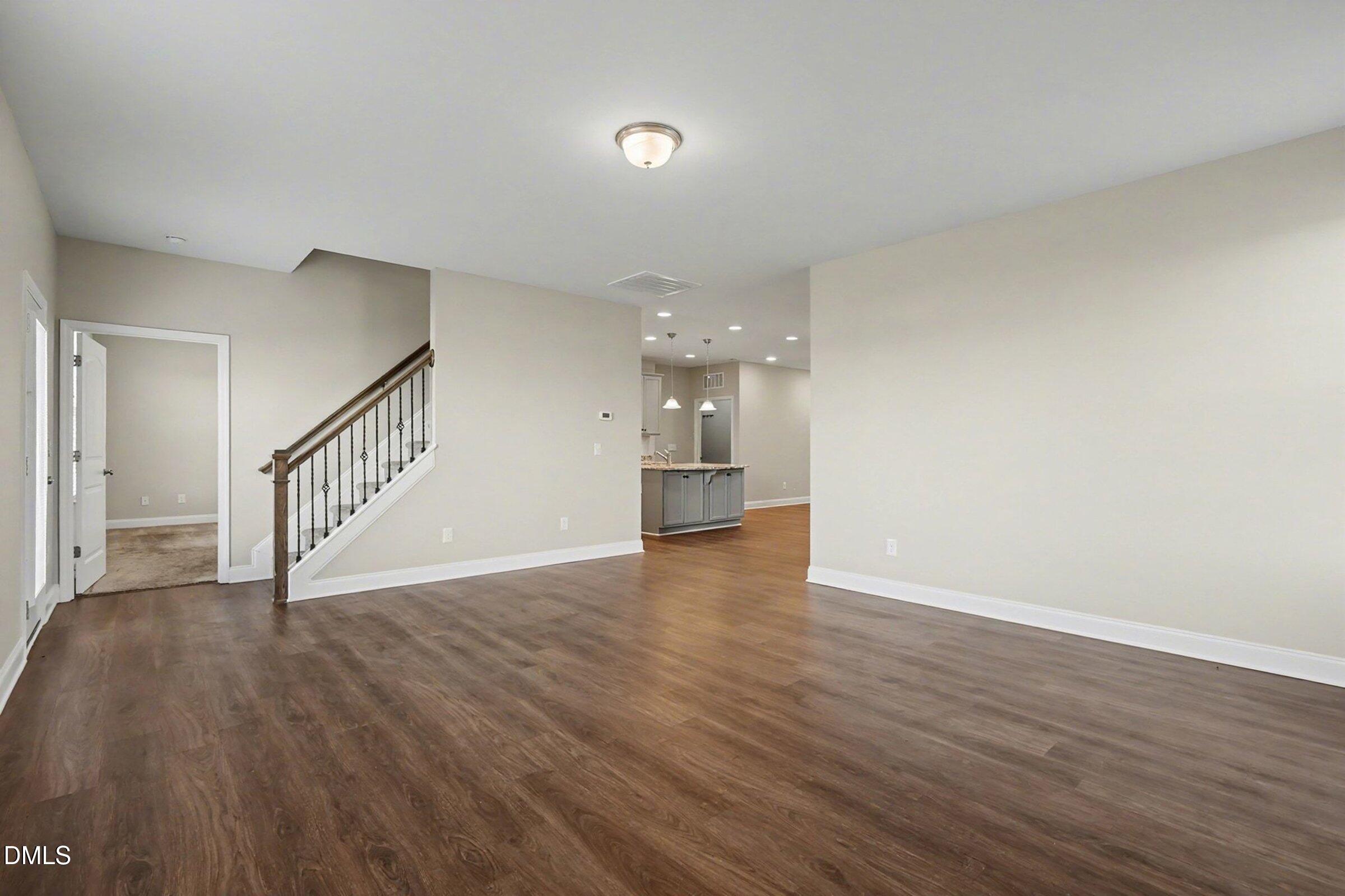 1946 Payne Road Haw River, NC 27258 - Photo 5 of 37 a view of an empty room with wooden floor and a kitchen