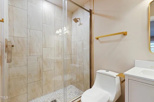 a bathroom with a toilet and a shower
