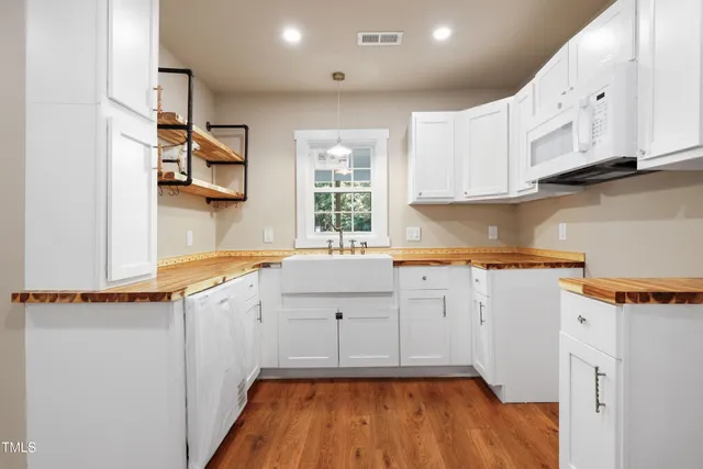 a kitchen with granite countertop a sink and cabinets