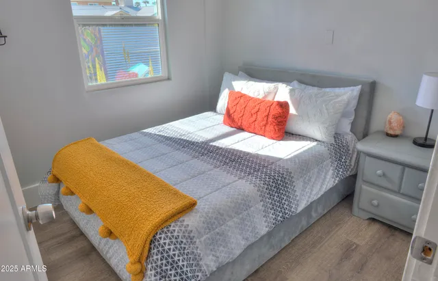 a bedroom with a bed and a lamp