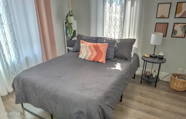 a bed sitting in a bedroom next to a window