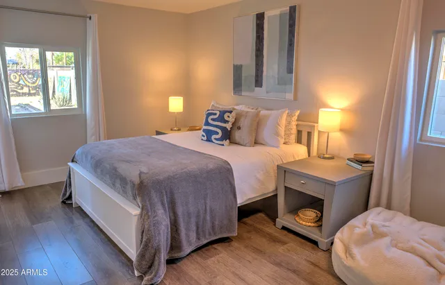 a bedroom with a bed and wooden floor