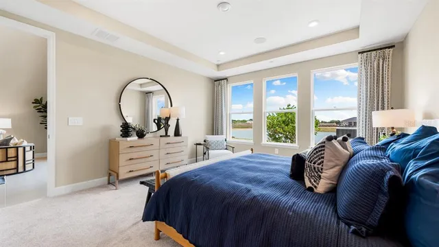 a bedroom with a bed and a chandelier