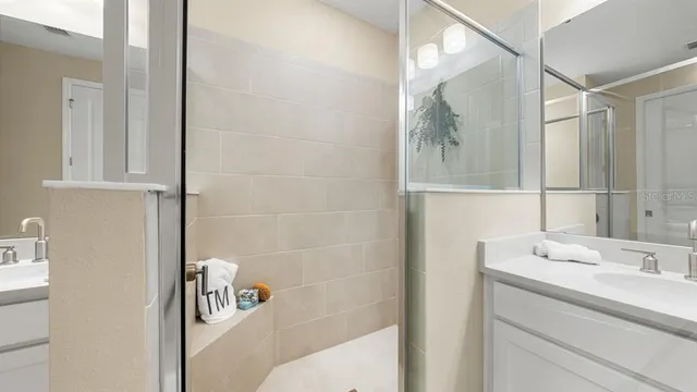 a bathroom with a toilet a sink a tub and a mirror