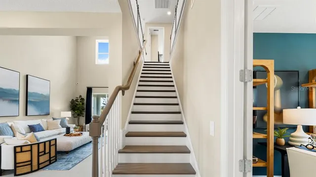 a view of a living room and hall way with furniture