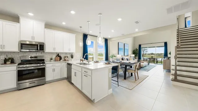 a view of a a dining room with furniture window and wooden floor