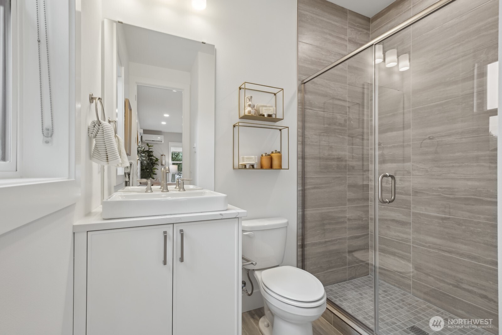 18809 99th Place Northeast, Unit A Bothell, WA 98011 - Photo 6 of 27 a bathroom with a sink a toilet and shower
