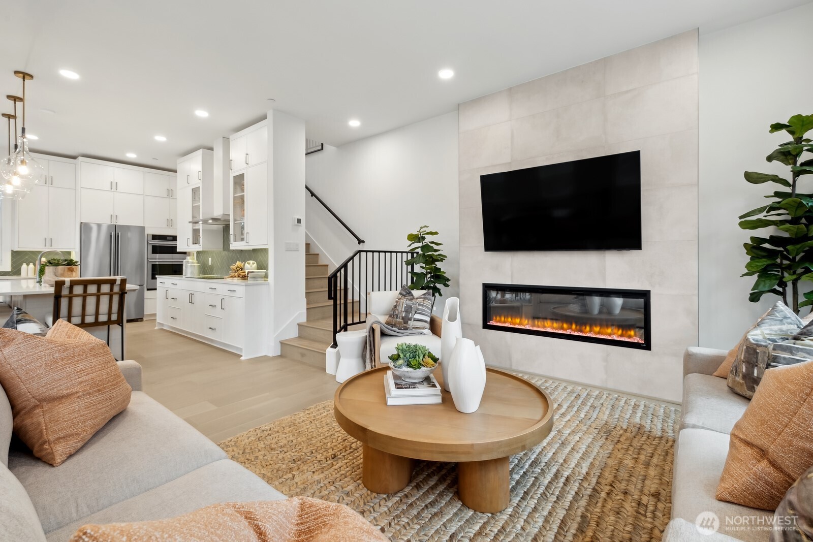 18809 99th Place Northeast, Unit A Bothell, WA 98011 - Photo 10 of 27 a living room with furniture a fireplace and a flat screen tv