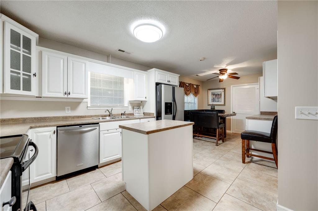 110 Pinewood Way Dalton, GA 30721 - Photo 22 of 35 a kitchen with sink cabinets and dining table