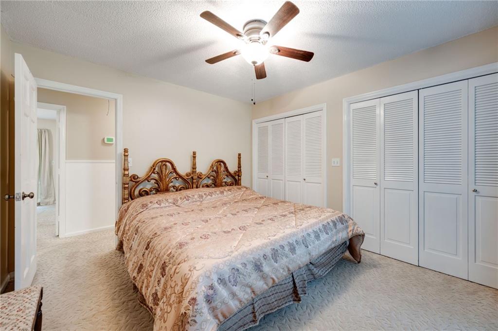 110 Pinewood Way Dalton, GA 30721 - Photo 28 of 35 a spacious bedroom with a bed and a ceiling fan