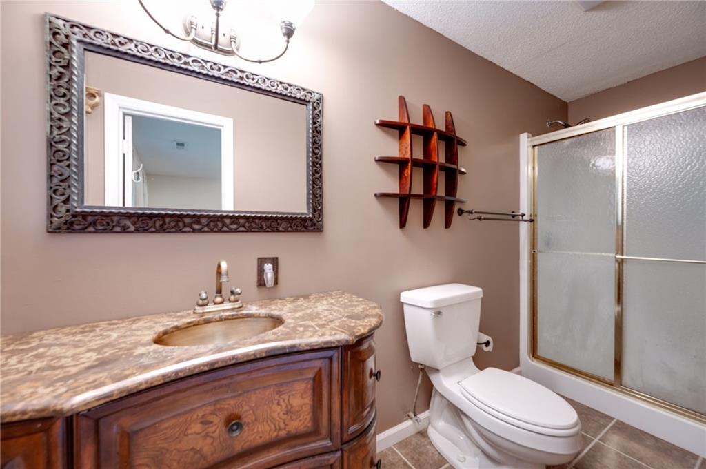 110 Pinewood Way Dalton, GA 30721 - Photo 34 of 35 a bathroom with a granite countertop toilet sink and mirror