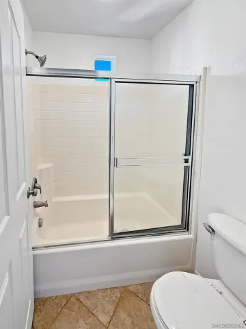 a bathroom with a shower and a toilet