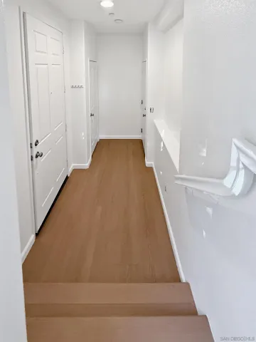 a view of a hallway with white walls