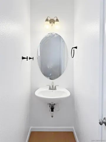 a bathroom with a sink a mirror and vanity