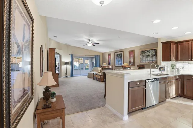 a kitchen with stainless steel appliances granite countertop a stove a refrigerator and a dining table