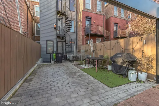 a view of a brick house with a yard and plants