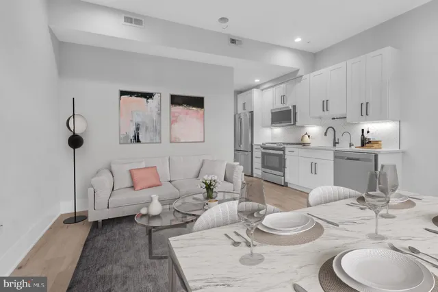 a living room with furniture and a kitchen view