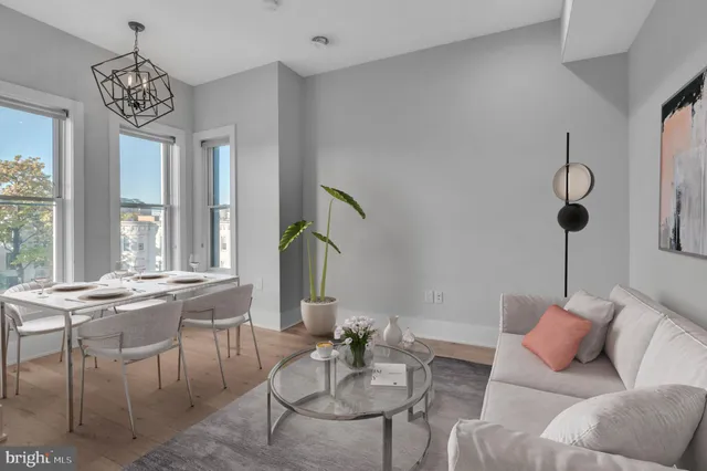 a living room with furniture and a chandelier