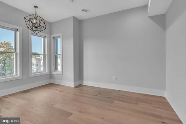 wooden floor in an empty room with a window