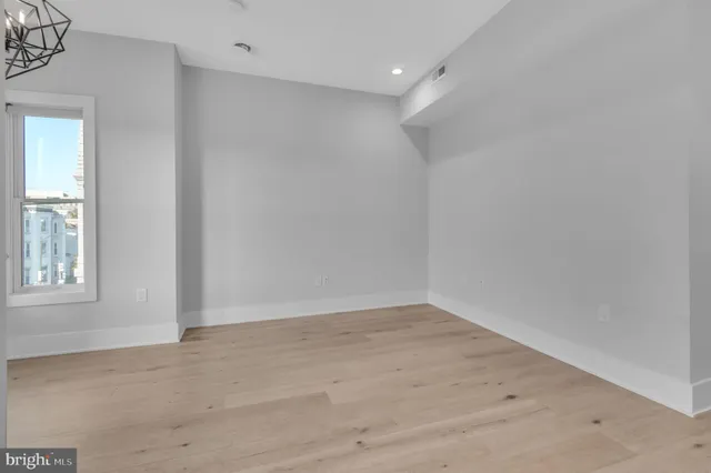 an empty room with windows and closet