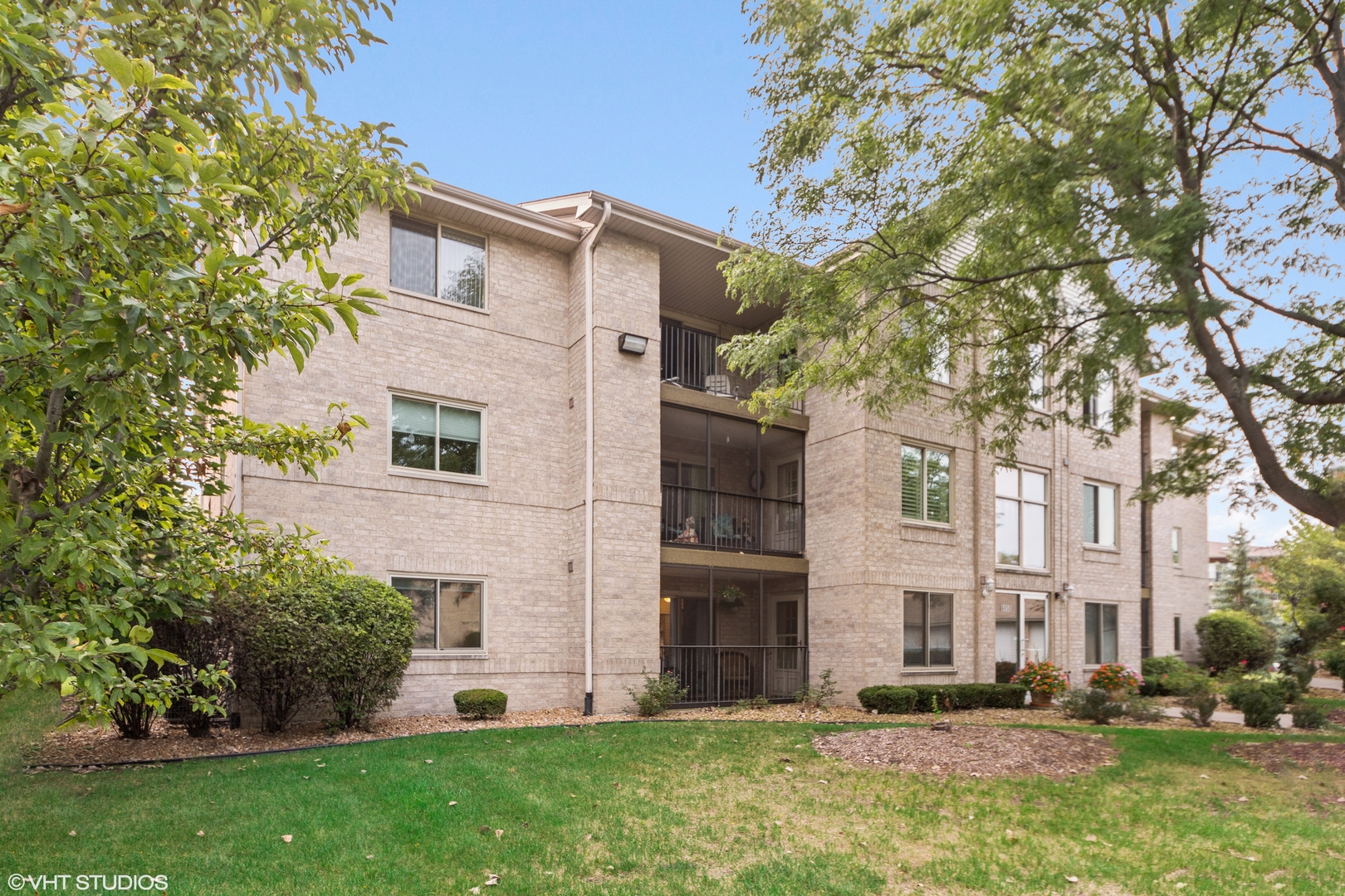 6850 Ridge Point Drive, Unit 1A Oak Forest, IL 60452 - Photo 2 of 20 a view of a white house with a large tree