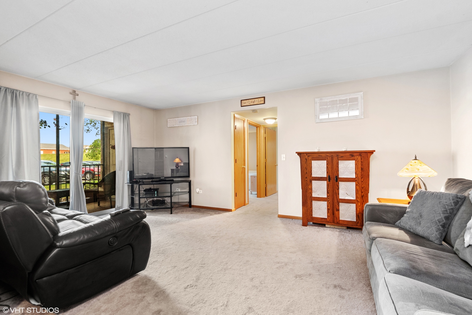 6850 Ridge Point Drive, Unit 1A Oak Forest, IL 60452 - Photo 7 of 20 a living room with furniture and a flat screen tv