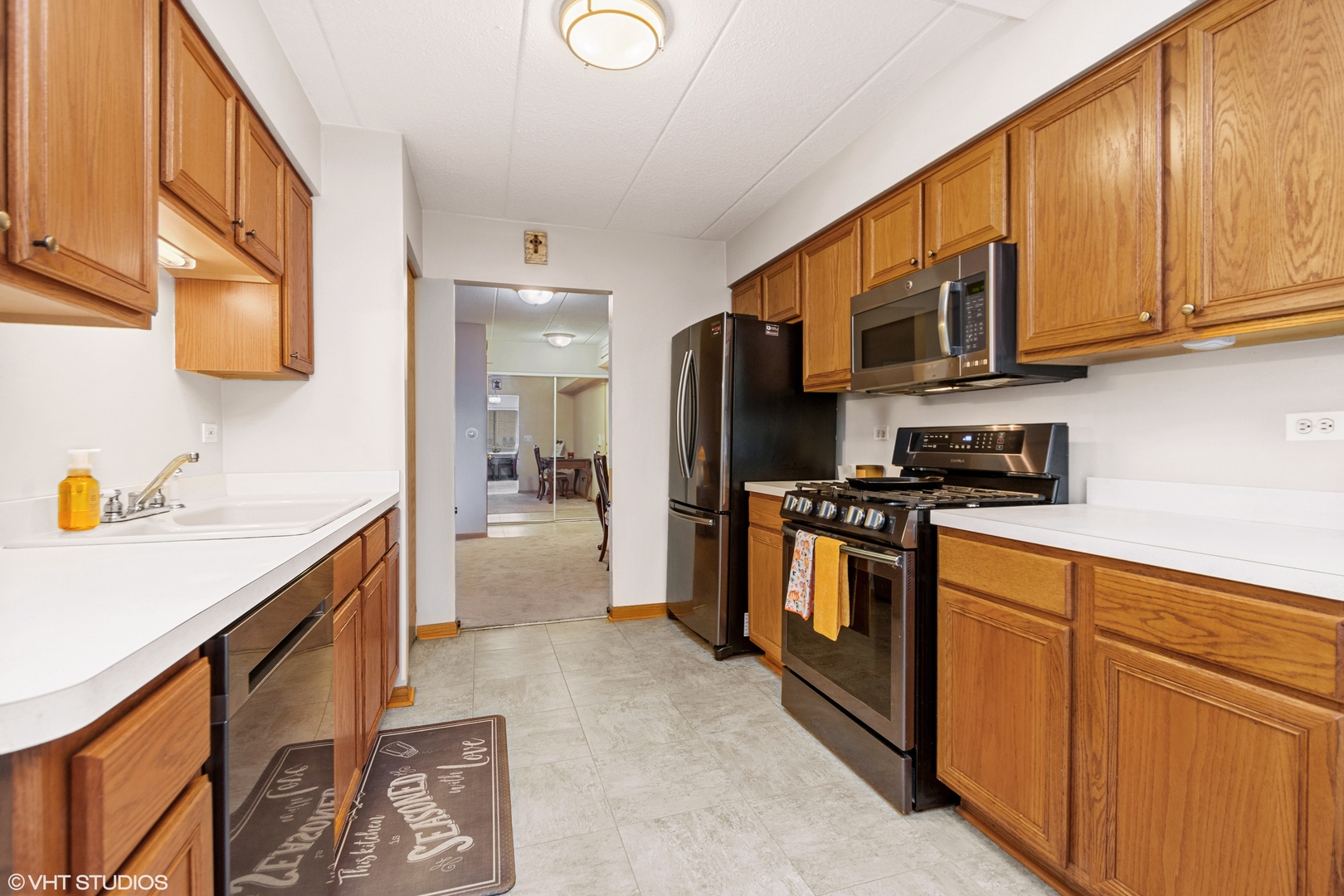 6850 Ridge Point Drive, Unit 1A Oak Forest, IL 60452 - Photo 9 of 20 a kitchen with stainless steel appliances granite countertop a refrigerator a stove top oven a sink and dishwasher